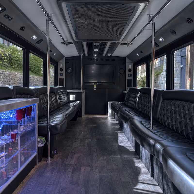 Friends laughing during a Raleigh party bus celebration