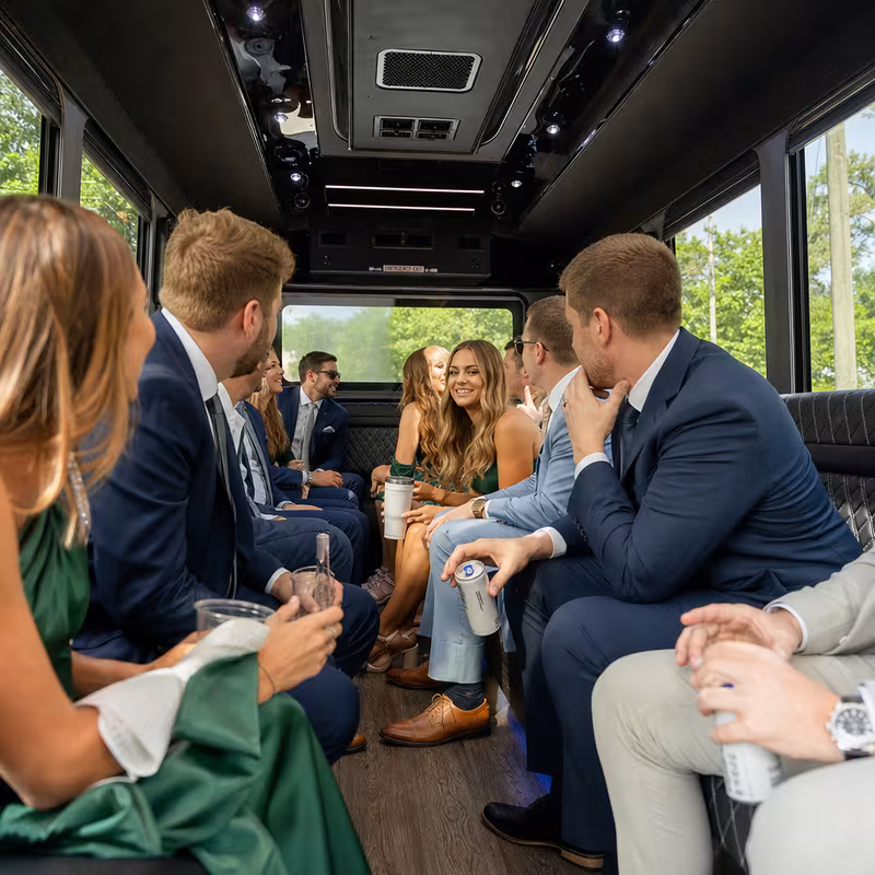 Wedding guests seated inside a Raleigh party bus