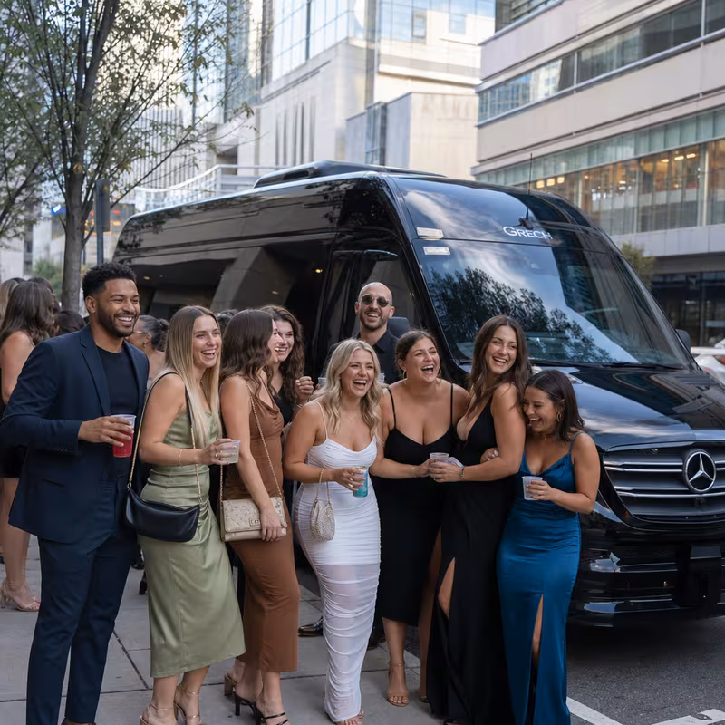 Group boarding a white charter bus for Bachelor & Bachelorette Transportation transportation in Raleigh