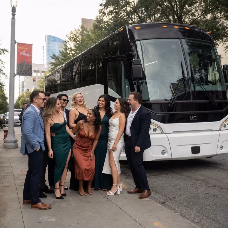 Passengers loading luggage while boarding an Raleigh group shuttle