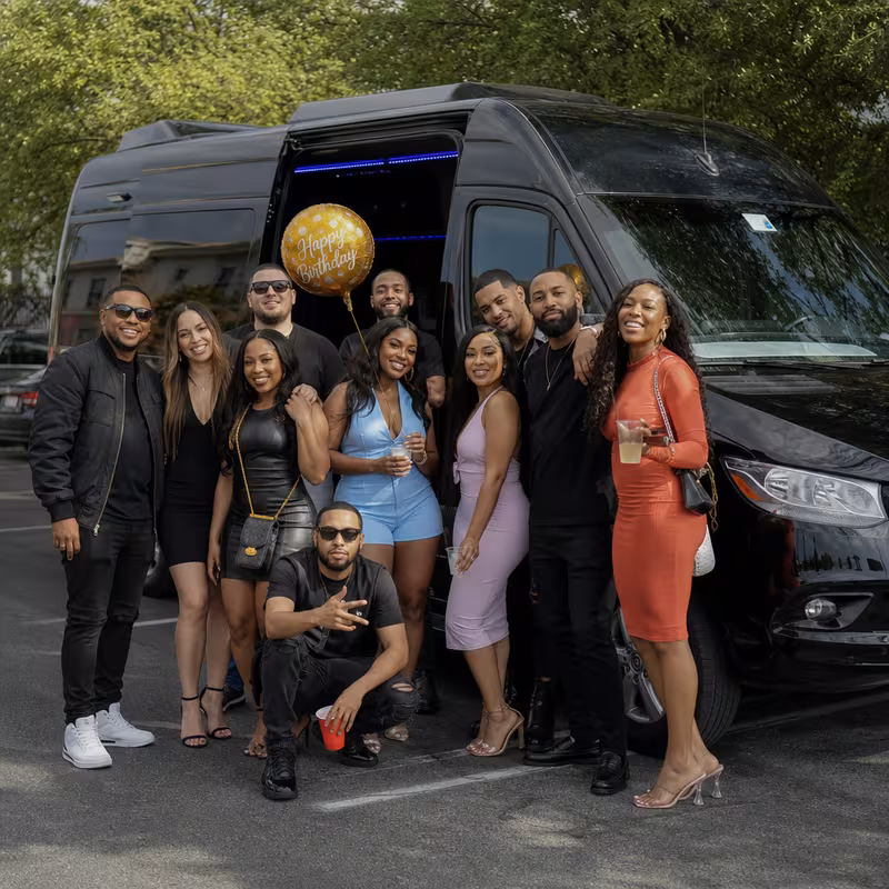 Group boarding a white charter bus for Birthday Transportation transportation in Raleigh
