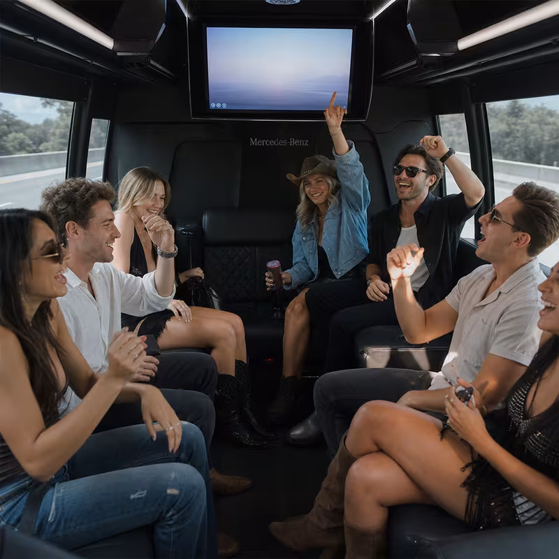 Group boarding a white charter bus for Concert Transportation transportation in Raleigh