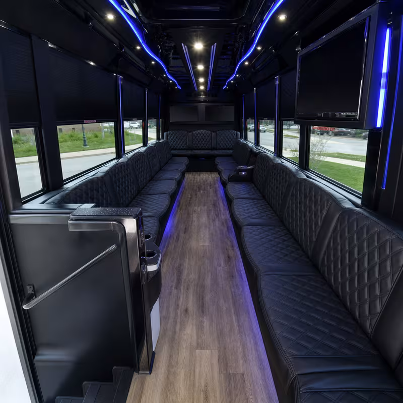 Party bus interior with wraparound leather seating and LED lighting in Raleigh