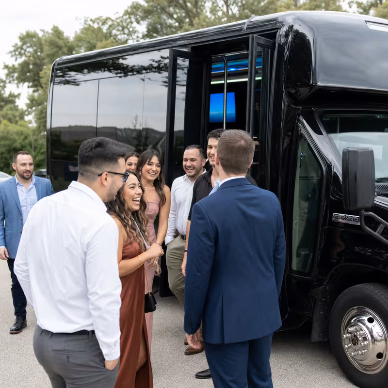 Passengers loading luggage while boarding an Raleigh group shuttle