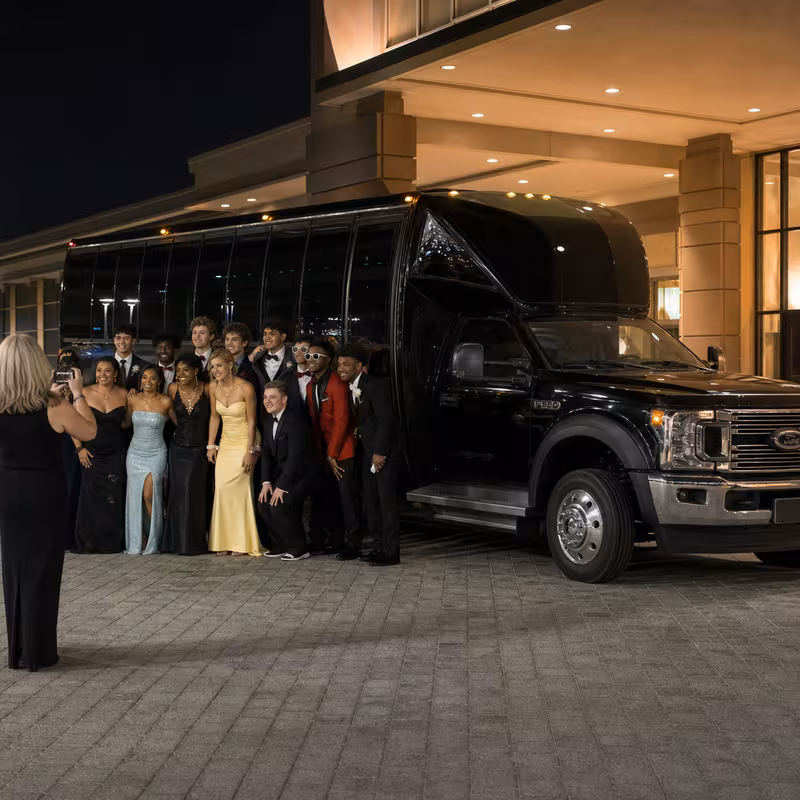 Party bus interior with wraparound leather seating and LED lighting in Raleigh
