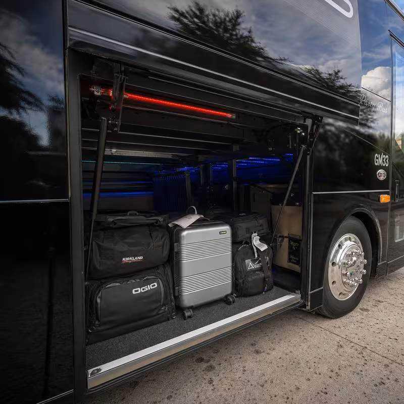 Party bus interior with wraparound leather seating and LED lighting in Raleigh
