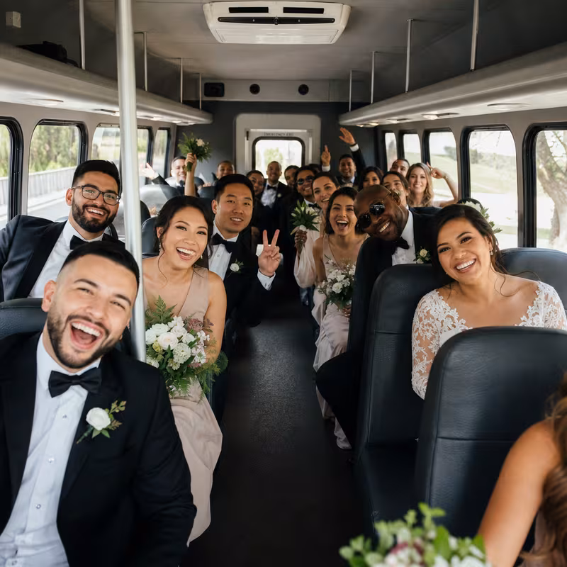Group boarding a white charter bus for Wedding Transportation transportation in Raleigh