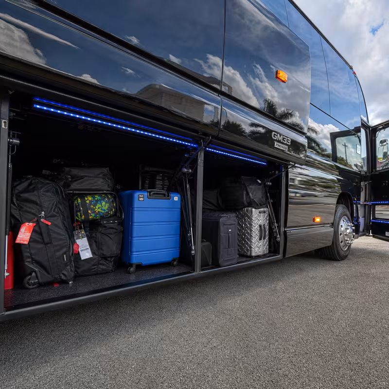 Party bus interior with wraparound leather seating and LED lighting in Raleigh